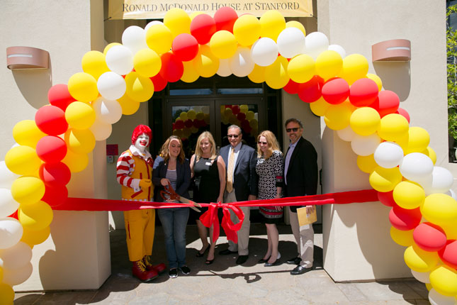 Ronald McDonald joined a current resident; CEO Annette Eros; Steven Ramirez, board chair for Ronald McDonald House Charities; Karen Boyd, board president for Ronald McDonald House at Stanford; and Rick Mayerson of Taube Investments for the ribbon cutting of the newly remodeled Ronald McDonald House at Stanford Taube Family Center.