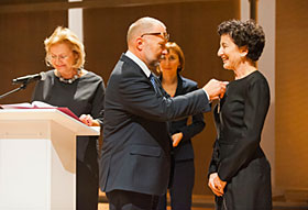 Minister Michałowski decorates Ms. Penn with the Commander's Cross of the Order of Merit of the Republic of Poland.