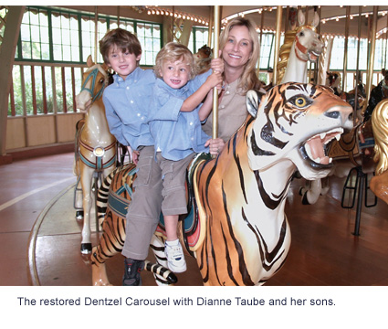The restored Dentzel Carousel with Dianne Taube and her sons.